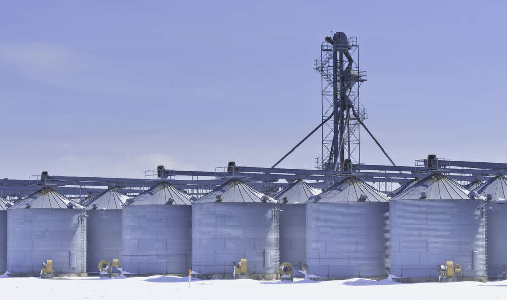 Steel grain silos and control tower above snow in March, central Illinois Steel grain silos and control tower above snow in March, central Illinois